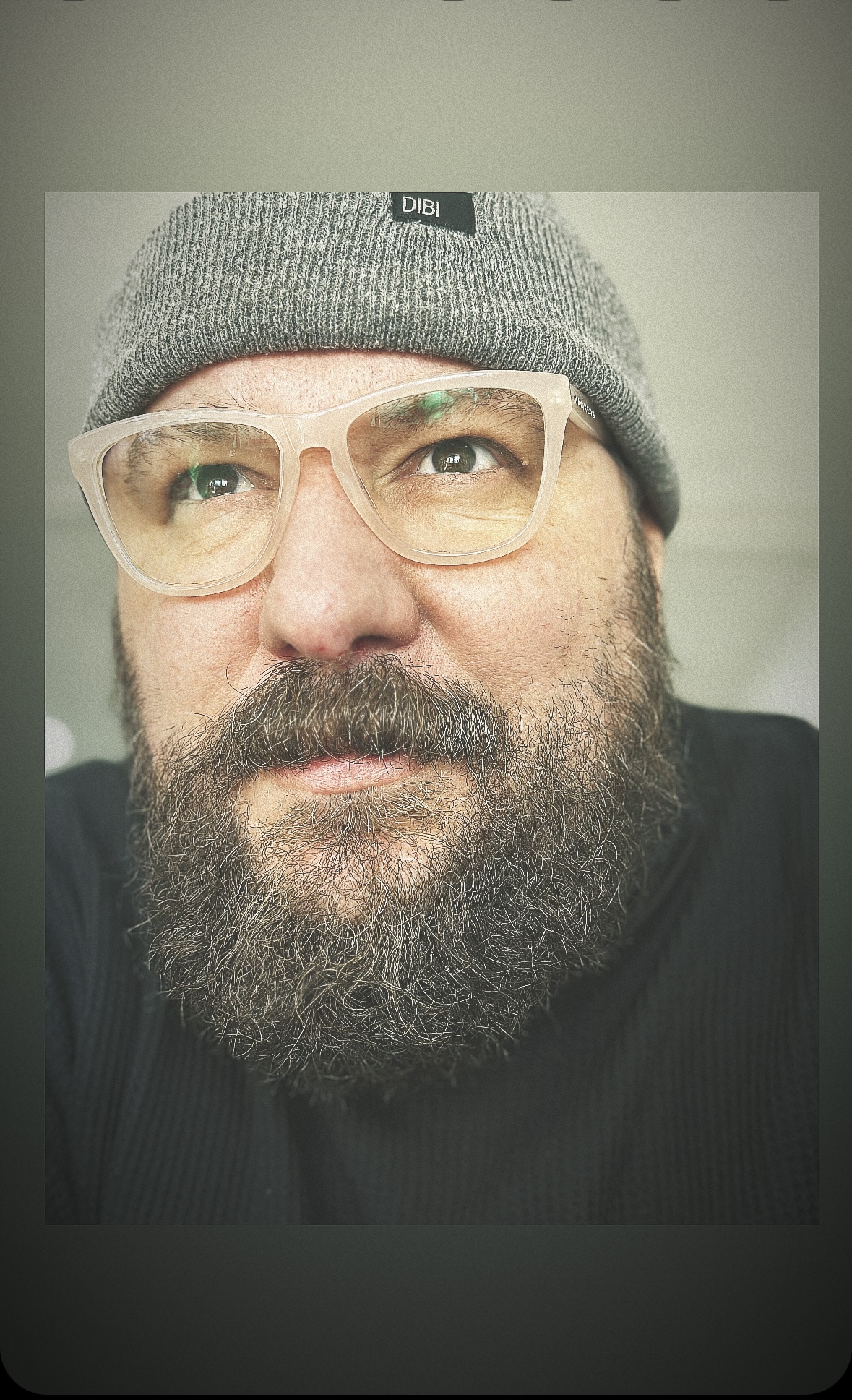 Close portrait of Ricardo Jovani wearing a beanie and glasses